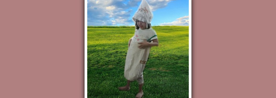 imagen niña con sindrome de down con disfraz hecho con 2 bolsas de tela