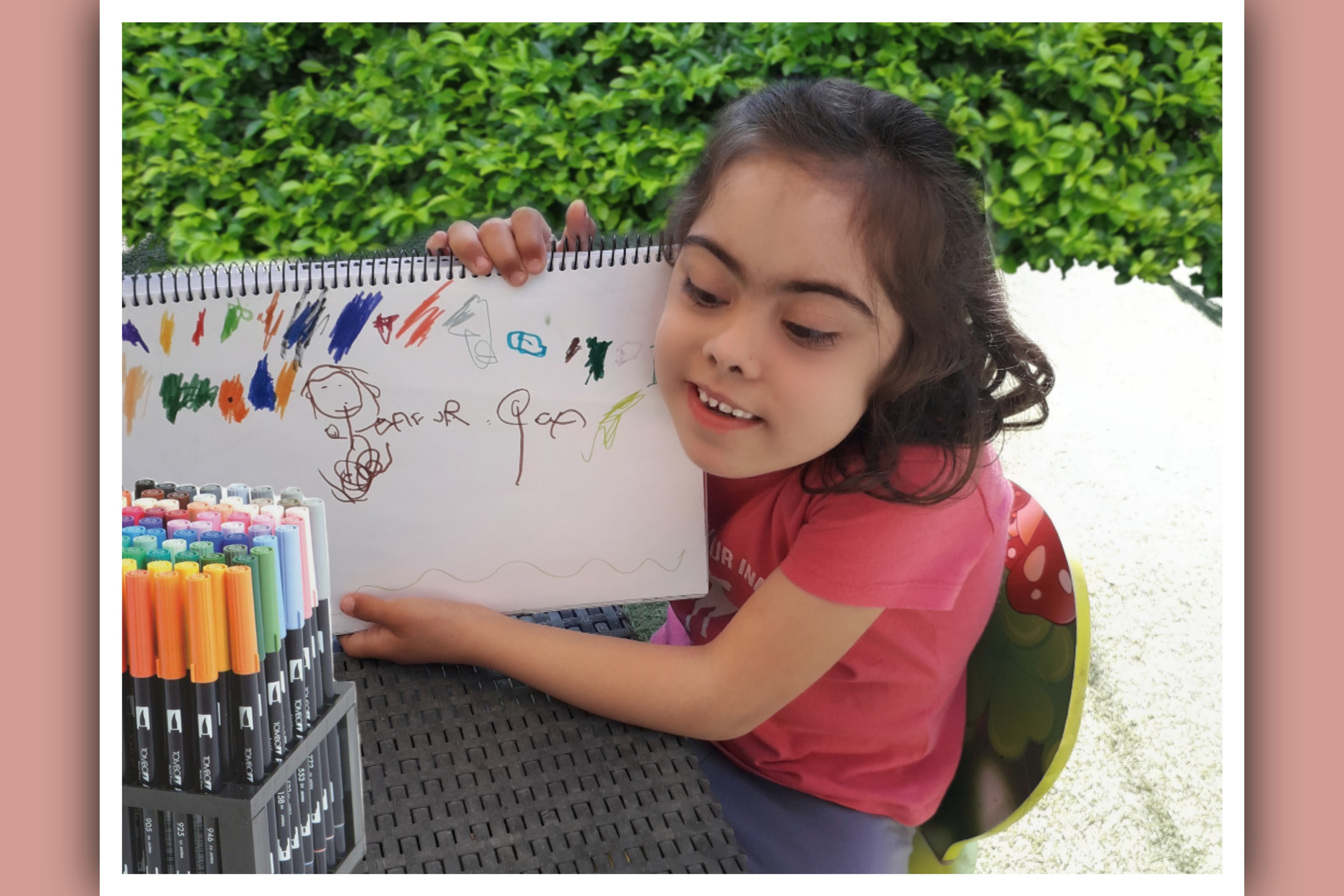 imagen niña sindrome down mostrando un dibujo